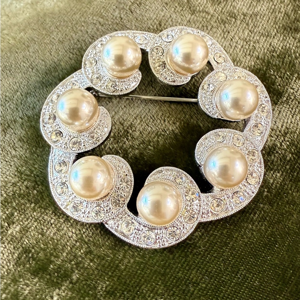 Simulated Pearls and Rhinestones in a silver color setting.